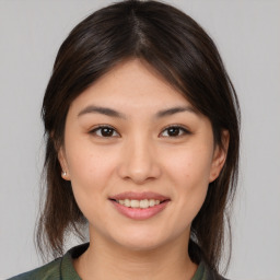 Joyful white young-adult female with medium  brown hair and brown eyes