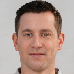 Joyful white adult male with short  brown hair and brown eyes