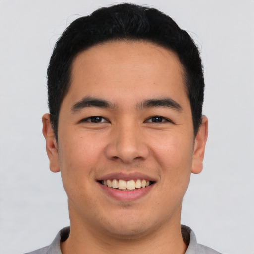 Joyful asian young-adult male with short  black hair and brown eyes