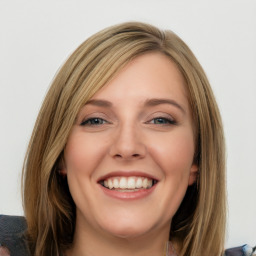 Joyful white young-adult female with long  brown hair and blue eyes