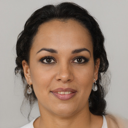 Joyful latino young-adult female with medium  brown hair and brown eyes