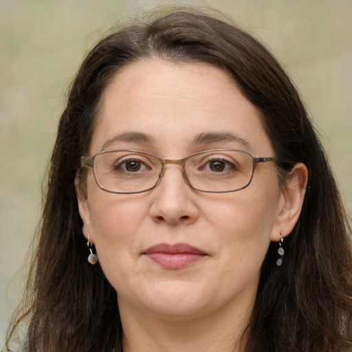 Joyful white adult female with long  brown hair and brown eyes