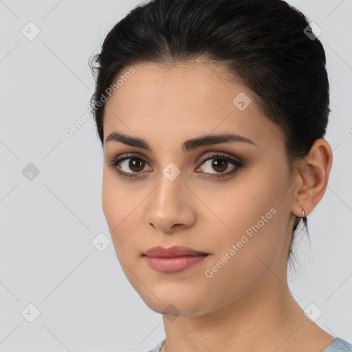 Joyful latino young-adult female with medium  brown hair and brown eyes