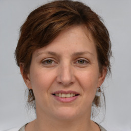 Joyful white adult female with medium  brown hair and grey eyes