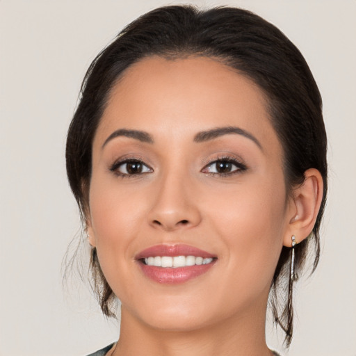 Joyful white young-adult female with medium  brown hair and brown eyes