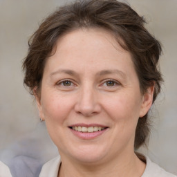 Joyful white adult female with medium  brown hair and brown eyes