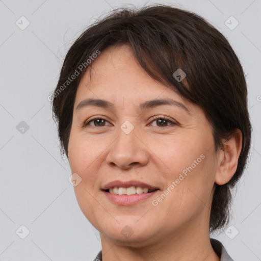 Joyful white adult female with medium  brown hair and brown eyes