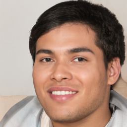 Joyful white young-adult male with short  black hair and brown eyes