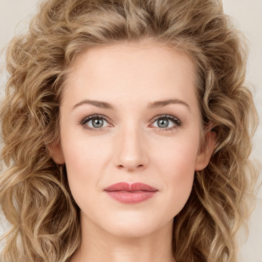 Joyful white young-adult female with long  brown hair and green eyes