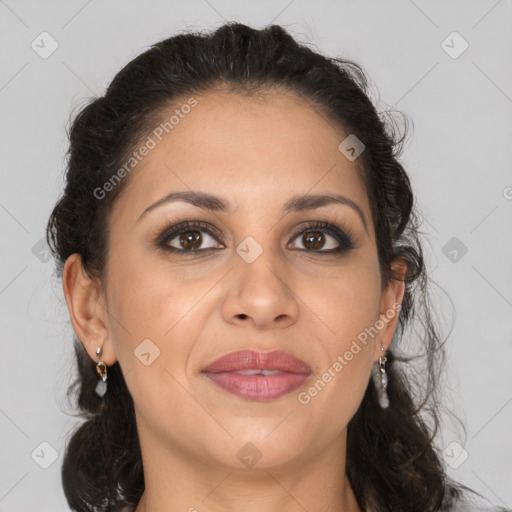 Joyful latino adult female with medium  brown hair and brown eyes