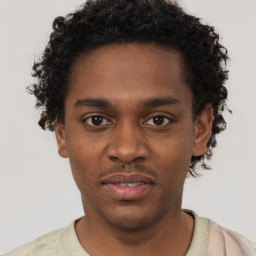 Joyful black young-adult male with short  brown hair and brown eyes