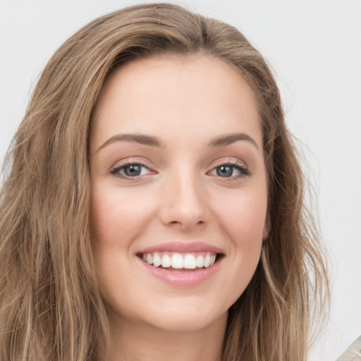 Joyful white young-adult female with long  brown hair and green eyes