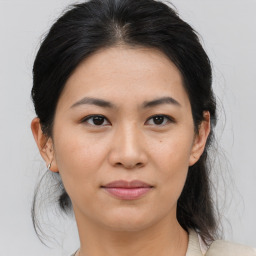 Joyful asian young-adult female with medium  brown hair and brown eyes