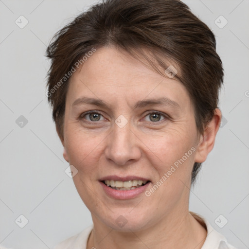 Joyful white adult female with short  brown hair and brown eyes