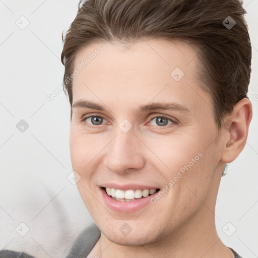 Joyful white young-adult female with short  brown hair and grey eyes