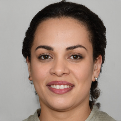 Joyful latino young-adult female with medium  brown hair and brown eyes