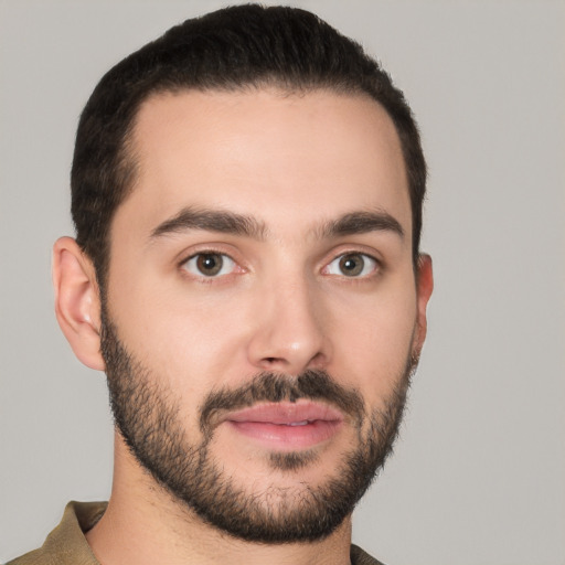 Joyful white young-adult male with short  black hair and brown eyes