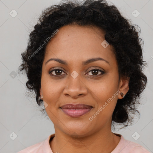 Joyful black young-adult female with long  brown hair and brown eyes