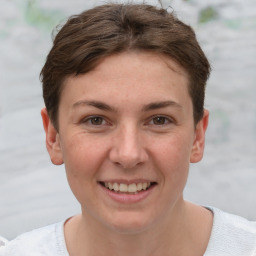 Joyful white young-adult female with short  brown hair and grey eyes