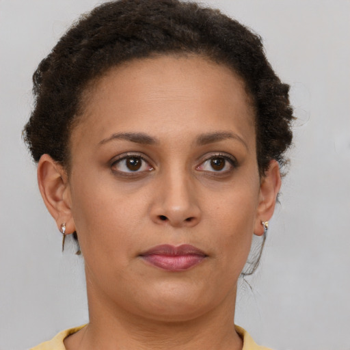 Joyful latino young-adult female with short  brown hair and brown eyes