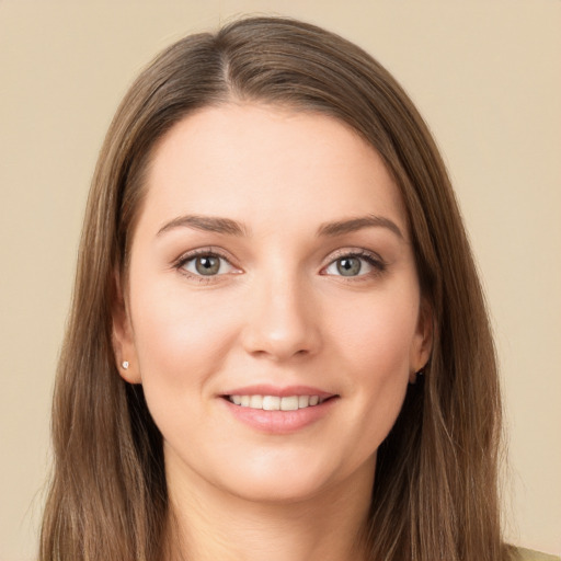 Joyful white young-adult female with long  brown hair and grey eyes