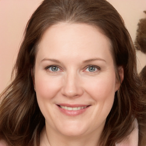 Joyful white adult female with long  brown hair and brown eyes