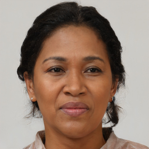 Joyful latino adult female with medium  brown hair and brown eyes