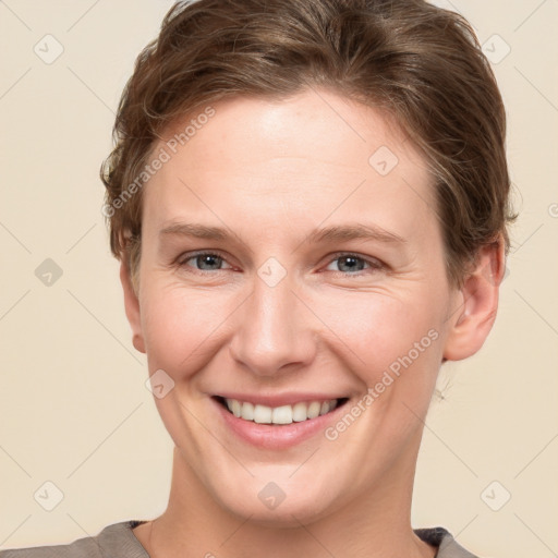 Joyful white young-adult female with short  brown hair and grey eyes