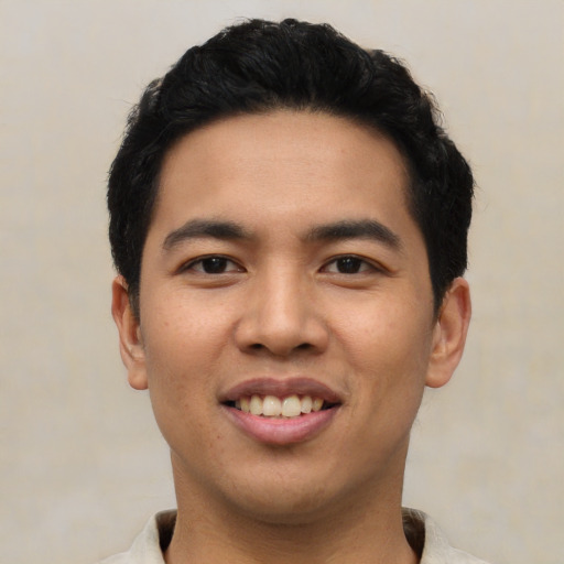 Joyful asian young-adult male with short  black hair and brown eyes