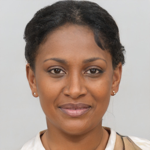 Joyful black young-adult female with short  brown hair and brown eyes