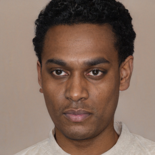 Neutral black young-adult male with short  black hair and brown eyes