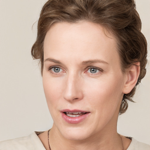 Joyful white young-adult female with medium  brown hair and blue eyes