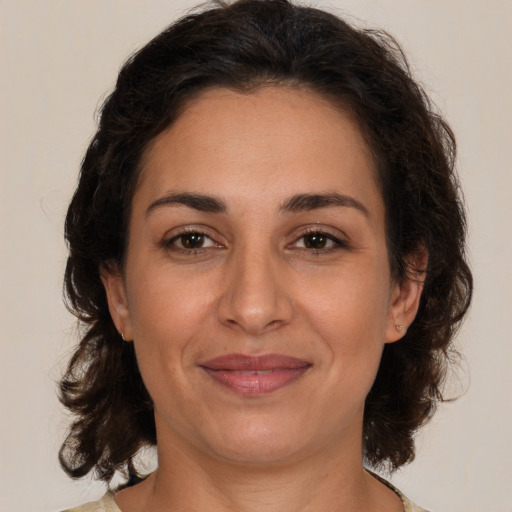 Joyful white adult female with medium  brown hair and brown eyes