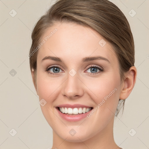 Joyful white young-adult female with medium  brown hair and green eyes