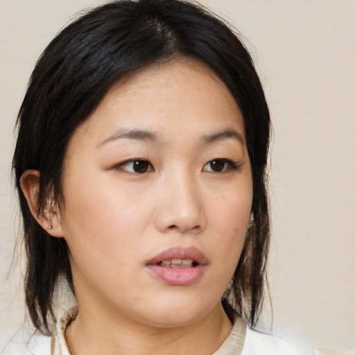 Neutral asian young-adult female with medium  brown hair and brown eyes