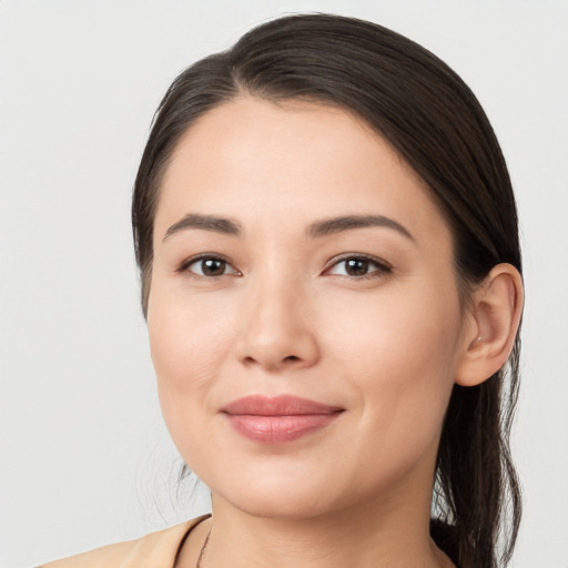 Joyful white young-adult female with long  brown hair and brown eyes