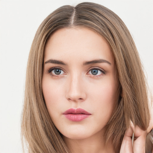 Neutral white young-adult female with long  brown hair and brown eyes