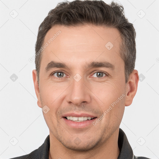 Joyful white adult male with short  brown hair and brown eyes