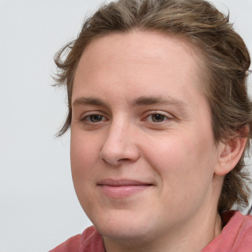 Joyful white young-adult female with medium  brown hair and blue eyes