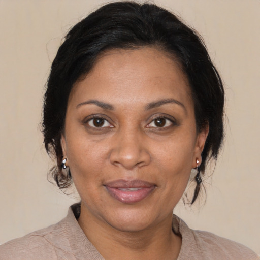 Joyful black adult female with medium  brown hair and brown eyes