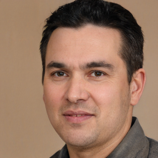 Joyful white adult male with short  brown hair and brown eyes