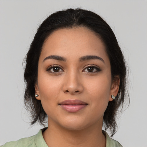 Joyful latino young-adult female with medium  brown hair and brown eyes