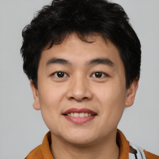 Joyful asian young-adult male with short  brown hair and brown eyes
