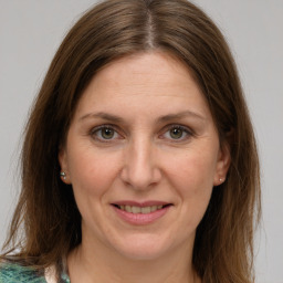 Joyful white adult female with medium  brown hair and grey eyes