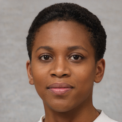 Joyful black young-adult female with short  brown hair and brown eyes