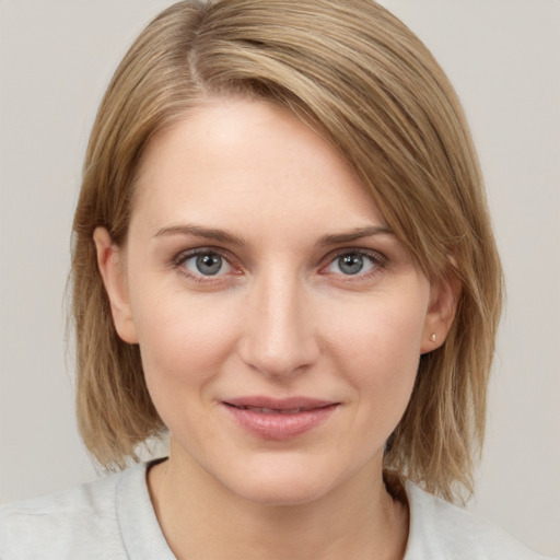 Joyful white young-adult female with medium  brown hair and blue eyes