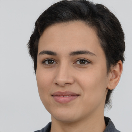 Joyful latino young-adult female with medium  brown hair and brown eyes