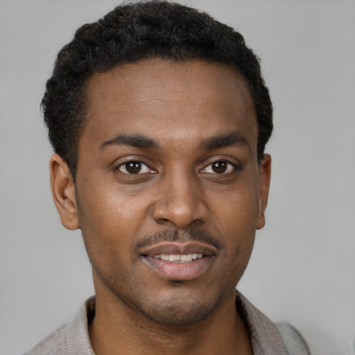Joyful latino young-adult male with short  brown hair and brown eyes