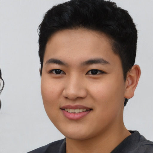 Joyful asian young-adult male with short  black hair and brown eyes