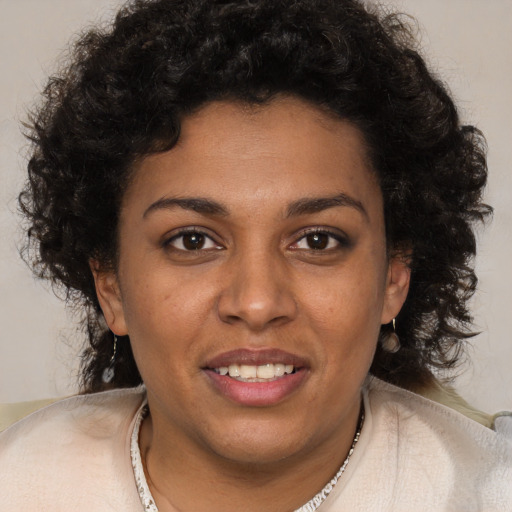 Joyful black young-adult female with short  brown hair and brown eyes